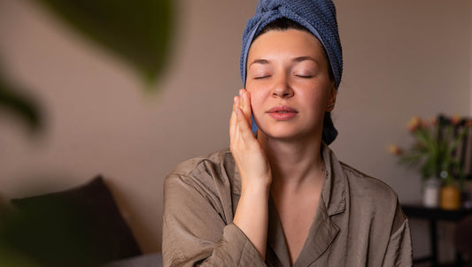Postpartum nighttime skincare routine: new mom applying gentle face cream at home, caring for her skin after pregnancy.